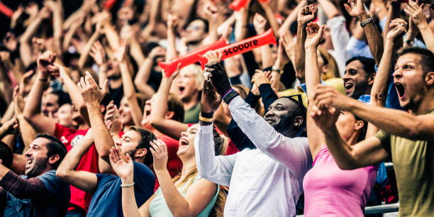 istock Crowd cheering for their team with arms raised 1126295339