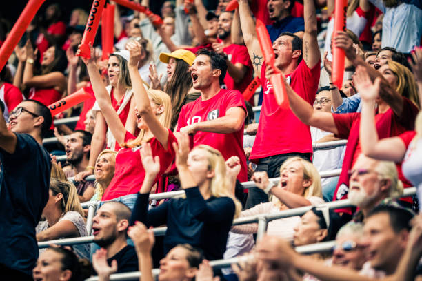 istock Crowd cheering for their team with arms raised 1126295344