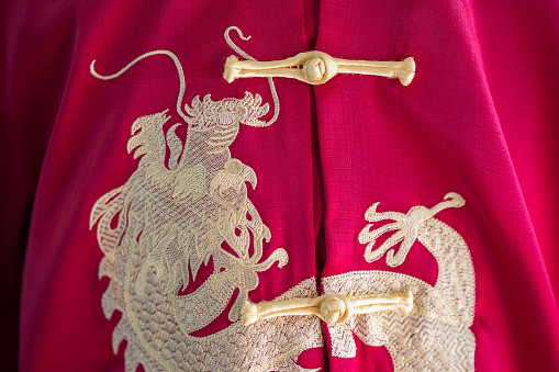 Embroidery chinese dragons on Chinese style red shirt background. Background concept of Chinese New Year