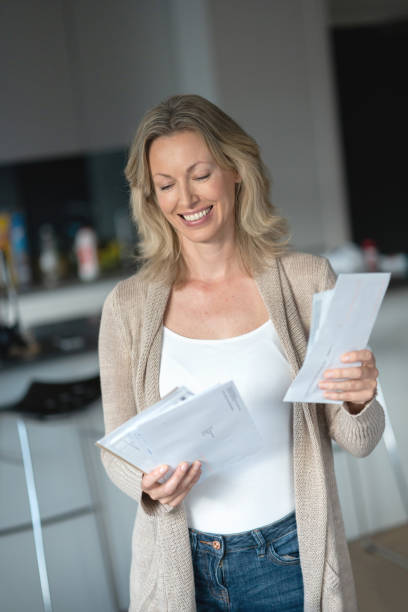 istock Beautiful woman at home checking the mail 1126300359
