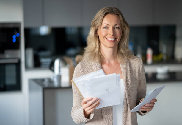 istock Happy woman at home checking her mail 1126300363