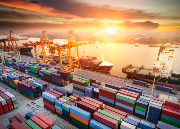 istock Logistics and transportation of Container Cargo ship and Cargo plane with working crane bridge in shipyard at sunset, logistic import export and transport industry background 1126300676
