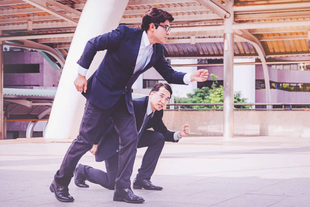 istock businessman at city standing in start position 1126303417