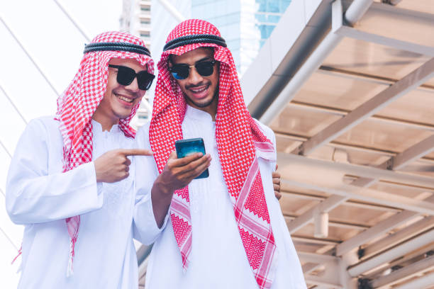istock Two Arab businessmen messaging on a mobile phone in city 1126303449