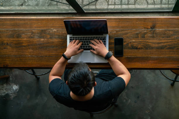 istock Asian man using laptop in the cafe 1126307191