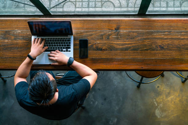istock High angle view of Asian man using laptop 1126307856