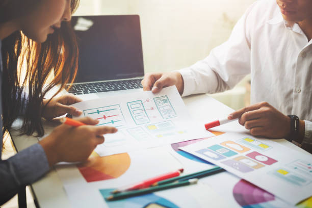 istock Designer working together to choose color swatch samples to editing artwork in the office. 1126308442