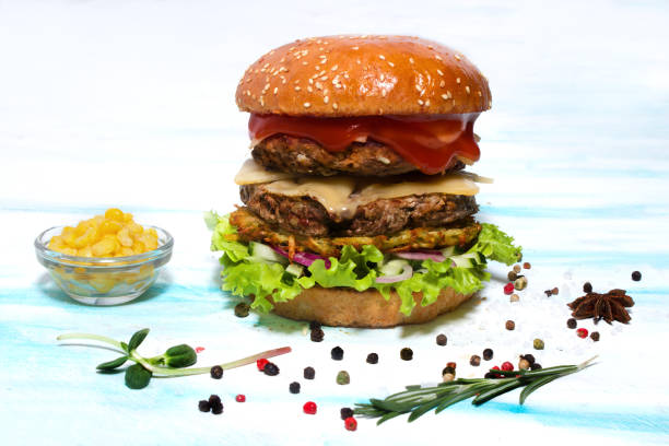 istock Juicy beef burger with cheese, ketchup, onions, potatoes and lettuce. Side view 1126311084