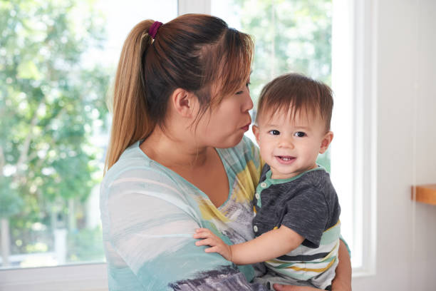 istock Mother kissing son 1126311263