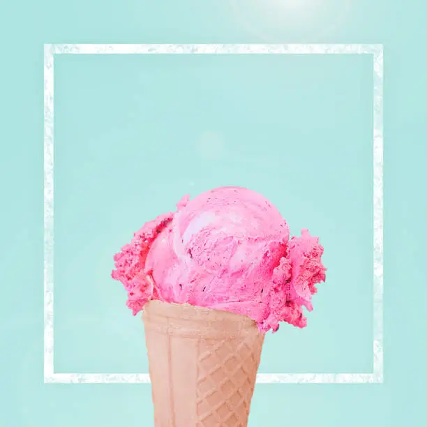 strawberry pink ice cream scoop on cone design on blue green pastel background with clipping path