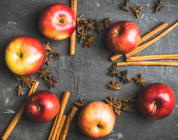 istock Apples with cinnamon and other spices on rustic wooden background 1126314110