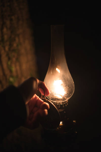 istock Man with kerosene lamp in the hands of night 1126322537
