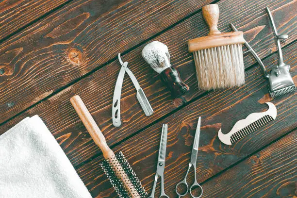 Photo of Barbershop accessories on wooden table. Barbershop background copy space