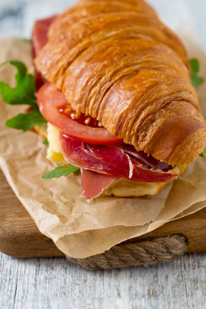 istock croissants with arugula, cheese and tomato on wooden surface 1126331626