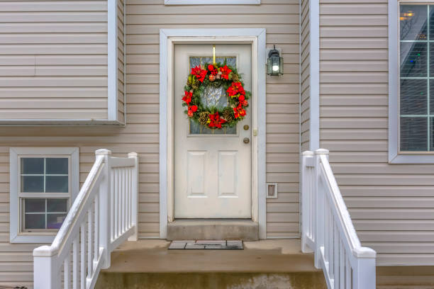 istock Stairs leading to front door with christmas wreath 1126332262