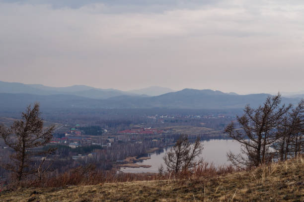 istock cloudy day outside the city. Gloomy spring landscape, mountains 1126332532