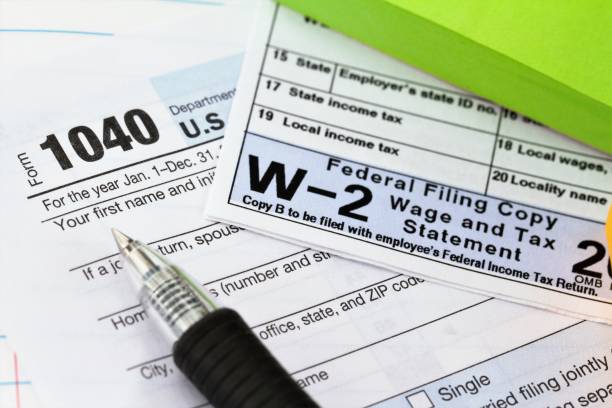 IRS 1040 tax form and w-2 wage statement: tax preparation concept. 1040 income tax form and w-2 wage statement. Tax preparation concept. 1040 tax form photos stock pictures, royalty-free photos & images