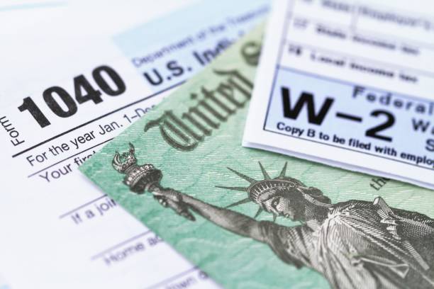 irs tax forms with tax refund check - tax imagens e fotografias de stock