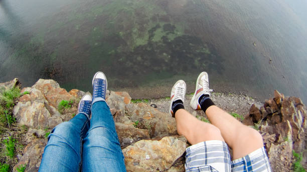istock Two travelers sit on break by the sea 1126339144