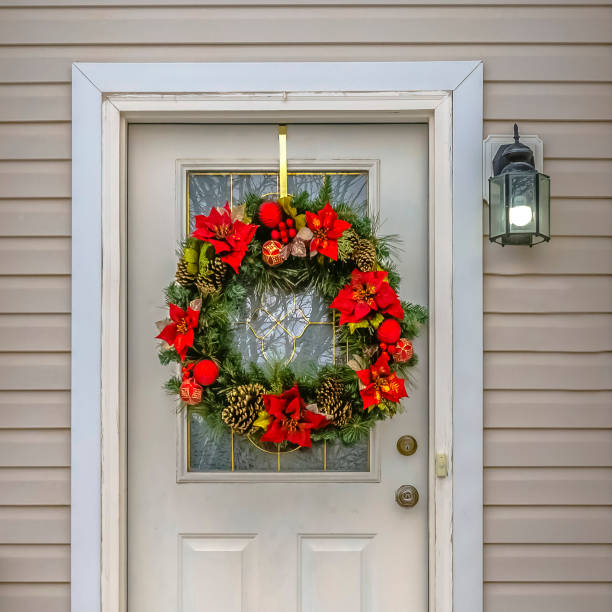 istock Christmas wreath hanging on a white front door 1126339519