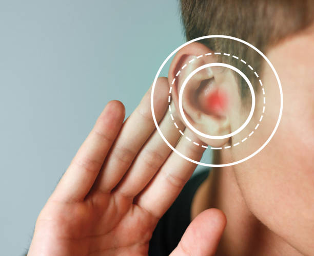 istock Young man with symptom of hearing loss on color background 1126343906