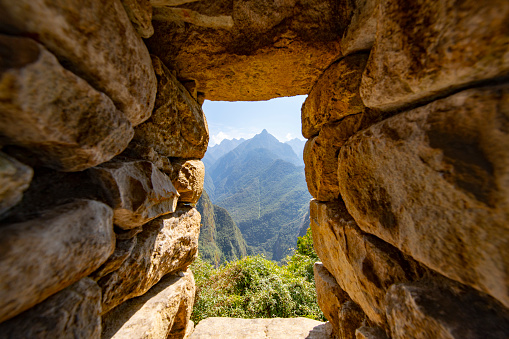 Looking through a window at Machu Picchu, the citadel of the Inca Empire located in Peru, South America.