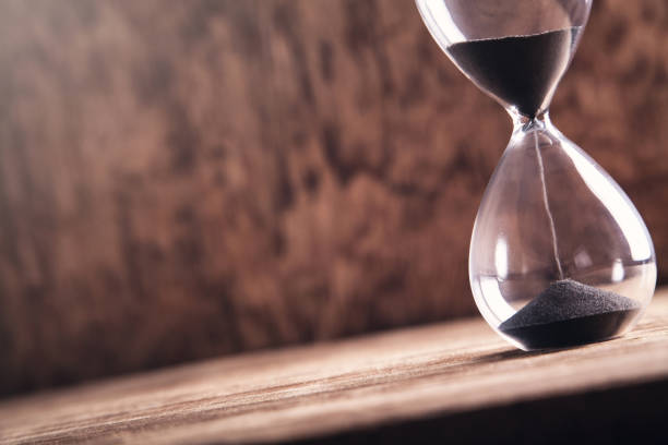 istock Hourglass on wooden background. Time 1126346765