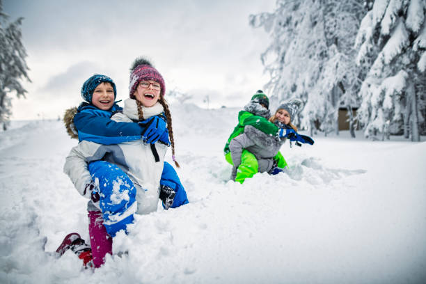 happy family playing in deep snow - group of people teenager snow winter imagens e fotografias de stock