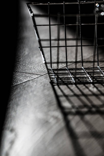 istock Bight metal basket shining on strong light over a wooden surface 1126351266
