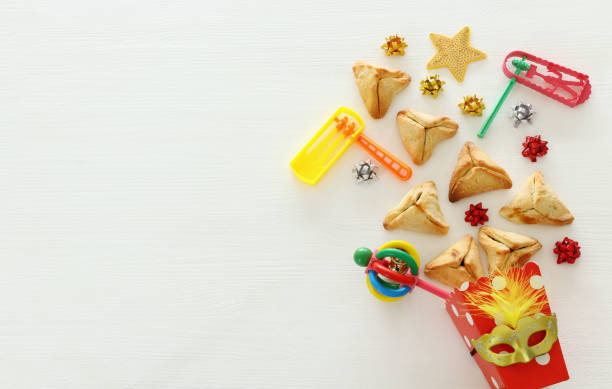 istock Purim celebration concept (jewish carnival holiday) over white wooden background. Top view, Flat lay. 1126351442