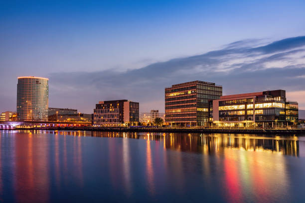 Belfast Cityscape River Lagan at Night Northern Ireland Belfast Cityscape at City Quays reflecting in the River Lagan at Twilight. City Quays, River Lagan Waterfront, Belfast, Northern Ireland, UK belfast stock pictures, royalty-free photos & images