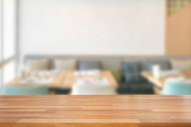 istock Empty wooden table and blurred modern white kitchen coffee cafe background, restaurants. 1126359586