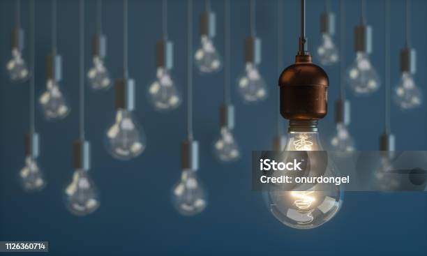 Light Bulb Standing Out From The Crowd Concepts Stock Photo - Download Image Now - Light Bulb, Inspiration, Ideas