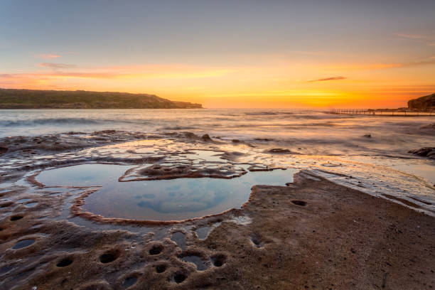istock Malabar coastal sunrise with foreground rocks and rock pools 1126364426