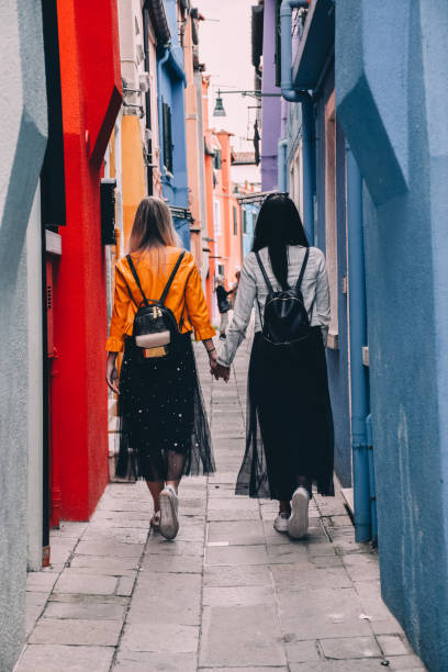 istock Young Lesbian Couple Exploring Venice Street Together 1126366895