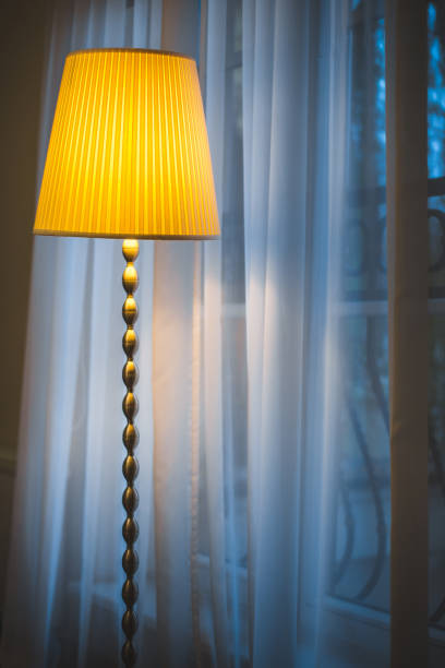 istock Cozy window seat under the lamp - winter outside the window 1126367596