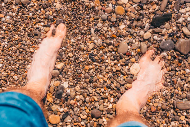 istock Wet pebbles on the beach - vacation time 1126367955
