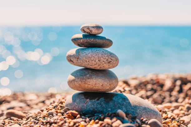 istock Stack of smooth sea zen stones on sea- spa concept - balance relaxation 1126368100