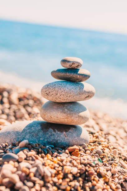 istock Stone pyramid on pebbles on beach - zen rock - balance and harmony 1126368662