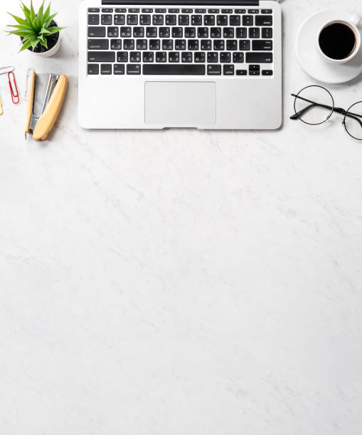 istock Stylized marble office working desk with smartphone, laptop, glasses and coffee, workspace design, mock up, topview, flatlay, copyspace, closeup 1126370156