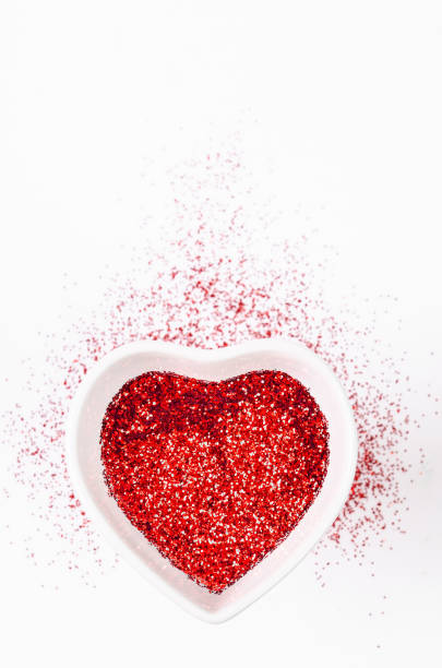 istock Heart shape made of red glitter on bright background. 1126371576