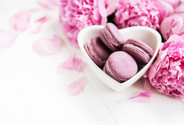 istock Pink peony flowers with macarons 1126372927