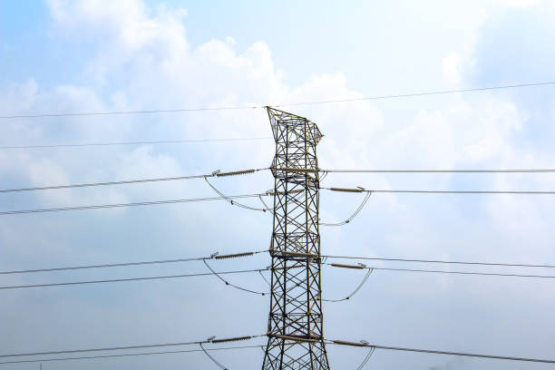 istock High-voltage power lines and transmission tower, outlined against a blue sky 1126372964