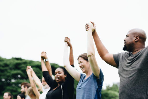 istock Happy diverse people holding hands in the park 1126376860