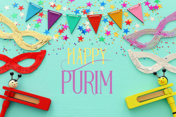 istock Purim celebration concept (jewish carnival holiday) over wooden blue background. 1126377262