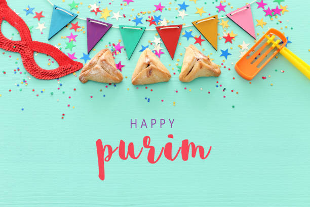 istock Purim celebration concept (jewish carnival holiday) over wooden mint background. 1126377280