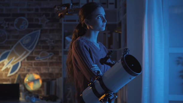 istock Young smart woman studying astronomy and watching the stars using a telescope, science and discovery concept 1126377525