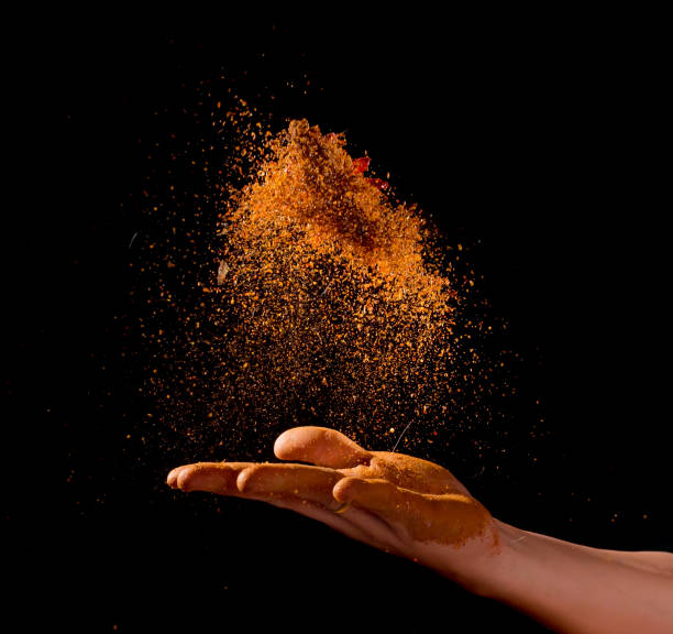 istock Cayenne pepper powder explosion with hand isolated on black background,Flying Cayenne pepper,Motion blur 1126378911