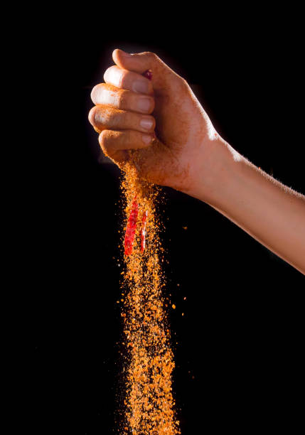 istock Hand sprinkling cayenne pepper,cayenne pepper on dark background 1126379047