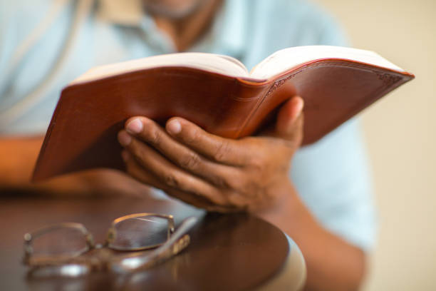 istock African American man praying and reading the Bible. 1126379062